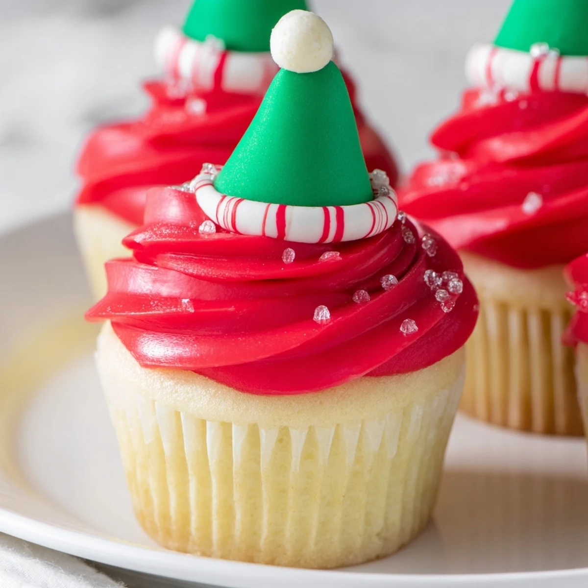 Close-up of an Elf Hat Cupcake tower, showcasing playful designs and delicious vanilla buttercream frosting.