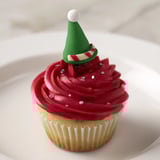 Freshly baked Elf Hat Cupcakes, beautifully decorated with colorful fondant and sprinkles; a sweet treat.