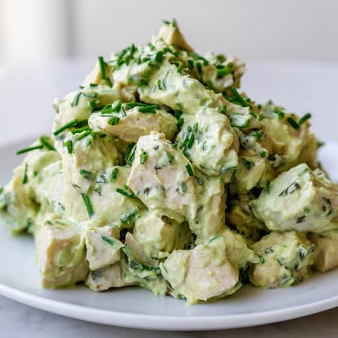 Savory Avocado Ranch Chicken Salad served on mixed greens with diced cucumber, cherry tomatoes and celery.