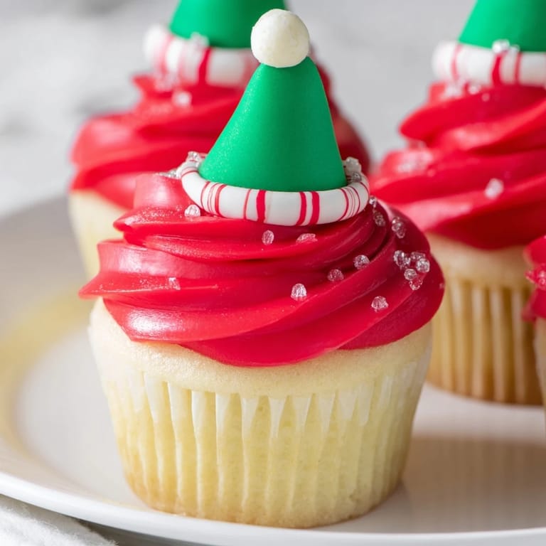 Close-up of an Elf Hat Cupcake tower, showcasing playful designs and delicious vanilla buttercream frosting.