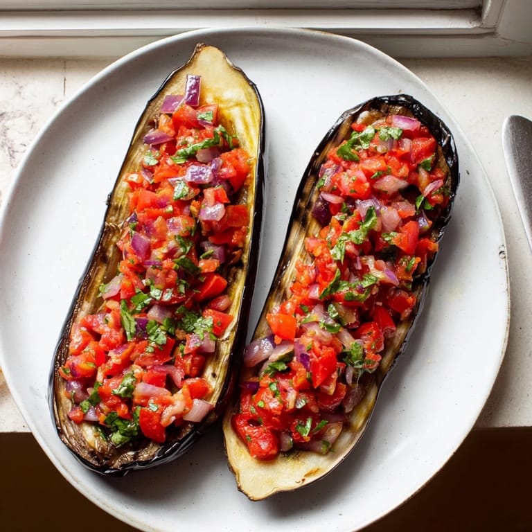 Delicious Imam Bayildi: The baked Turkish dish shows perfectly cooked eggplant alongside a vibrant, seasoned filling.