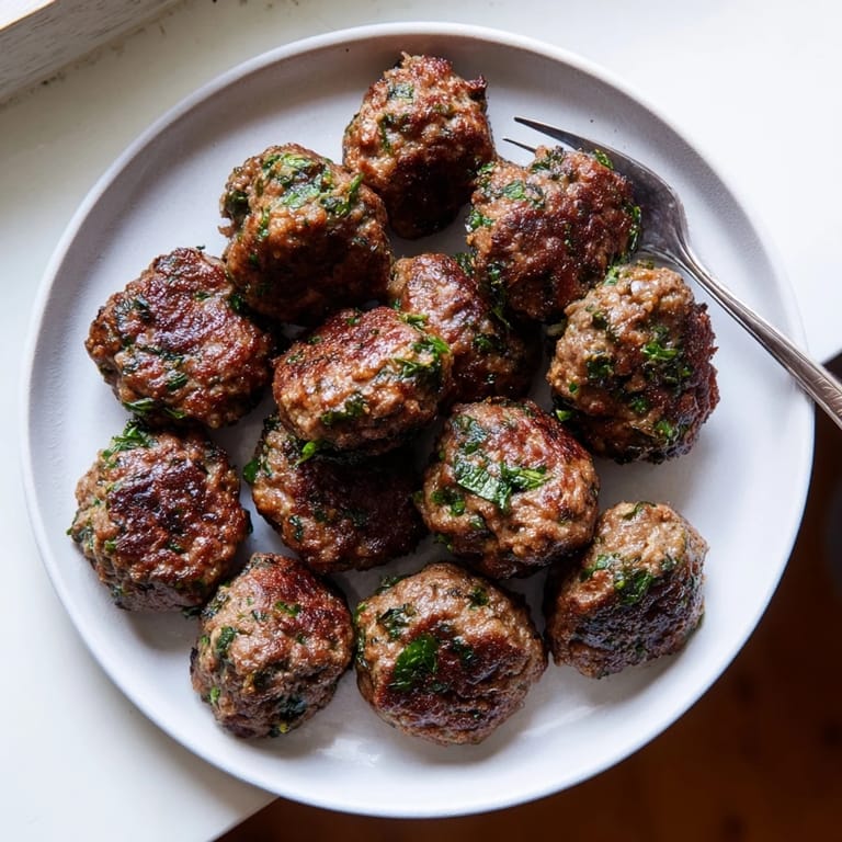 Close-up of a plate with savory Turkish Köfte meatballs, perfect for a hearty and satisfying main course.